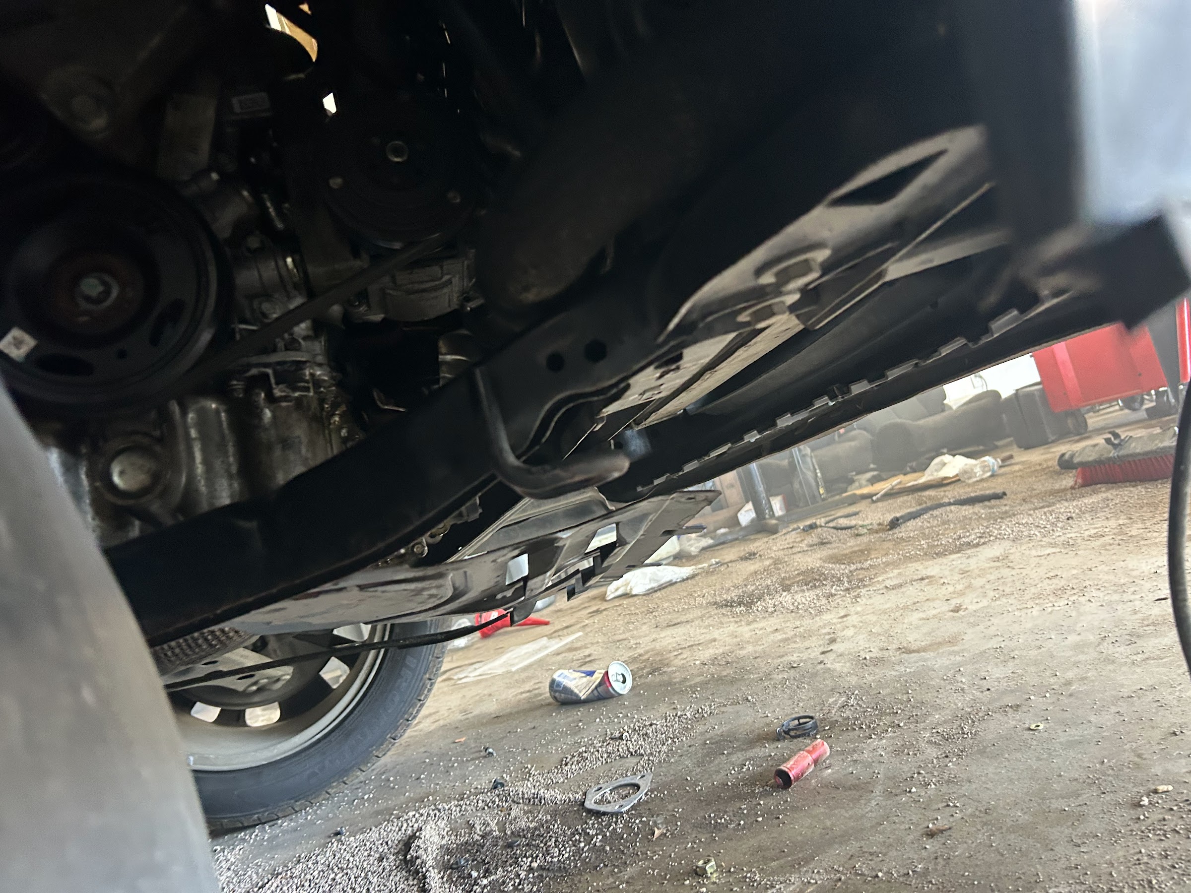 The underside of a vehicle raised for electrical diagnosis and repair
